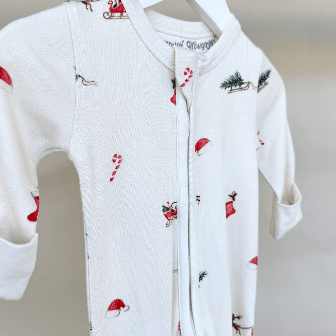 Close up of the Christmas Eve Sleepsuit with Santa and reindeer print from GrowGrows