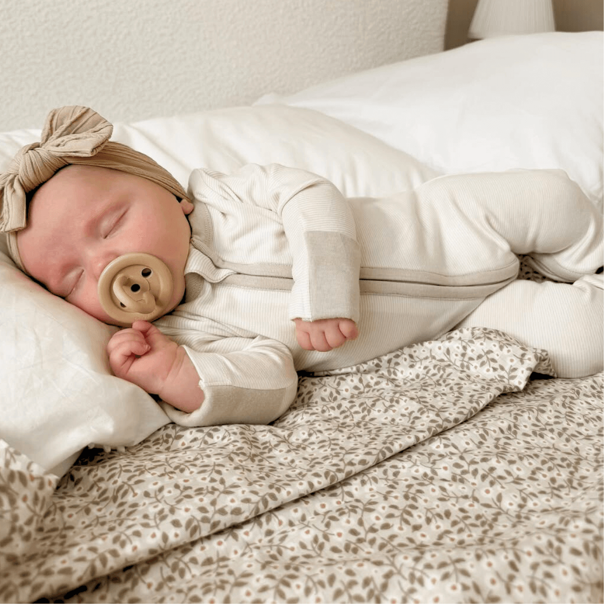 Baby sleeping peacefully wearing the Cashmere Pinstripe Sleepsuit with classic stripe design made from bamboo and organic cotton from GrowGrows