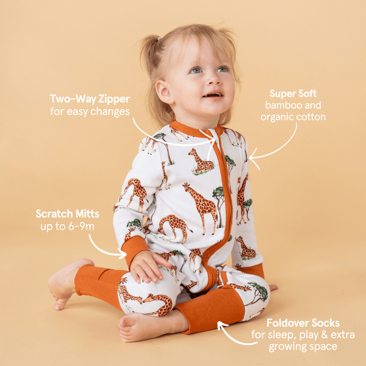 Gentle Giraffes Sleepsuit with mum and baby giraffe savannah print and desert orange trim made from bamboo and organic cotton from GrowGrows with the key features highlighted