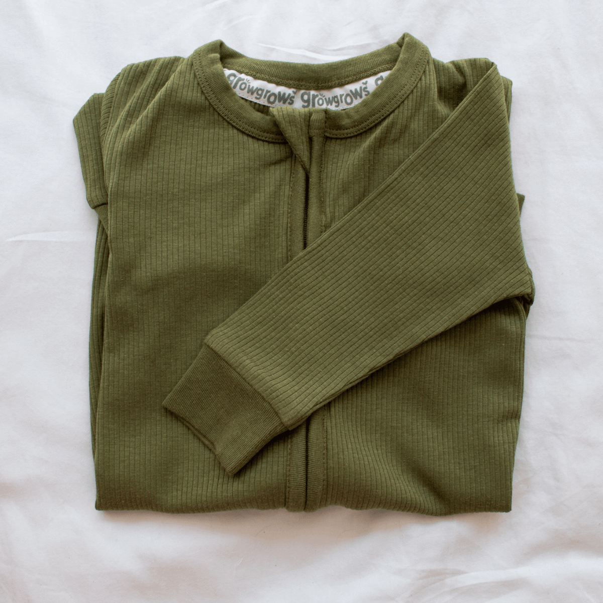 GrowGrows Forest Ribbed Sleepsuit folded on white background