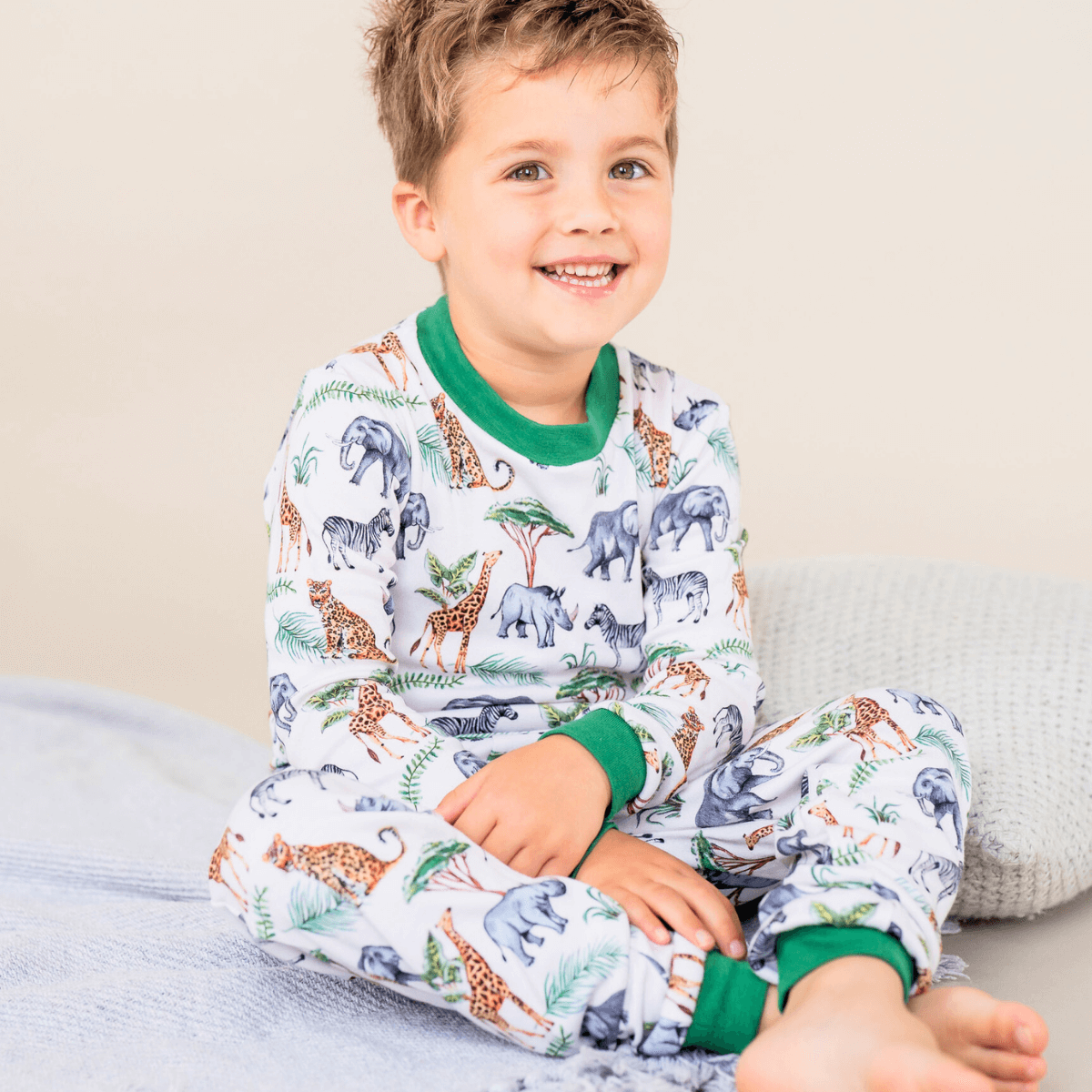 Child wearing the Safari Slumber Pyjamas with safari animal print made from bamboo and organic cotton from GrowGrows