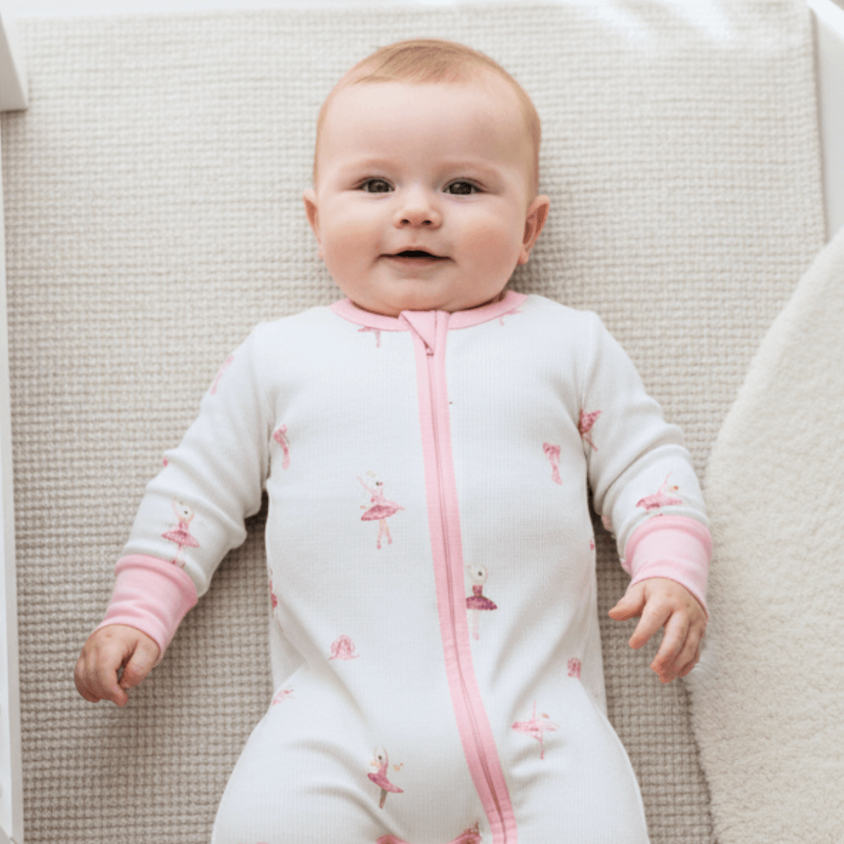 Baby wearing Tiny Twirls Sleepsuit with ballerina print made from bamboo and organic cotton from GrowGrows