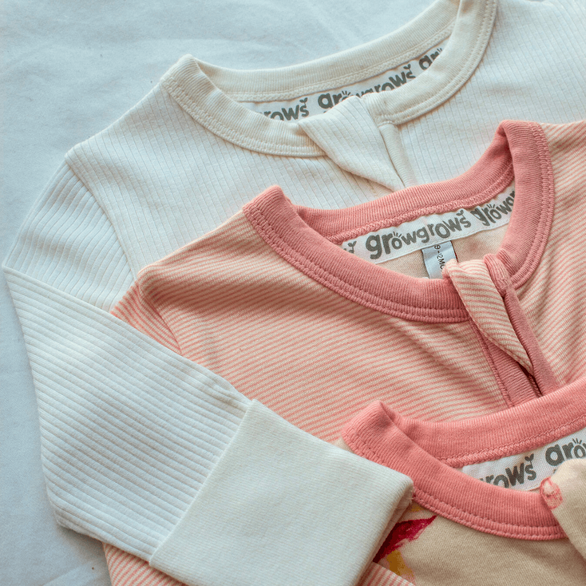Close up of the soft fabric on the GrowGrows White Ribbed Sleepsuit