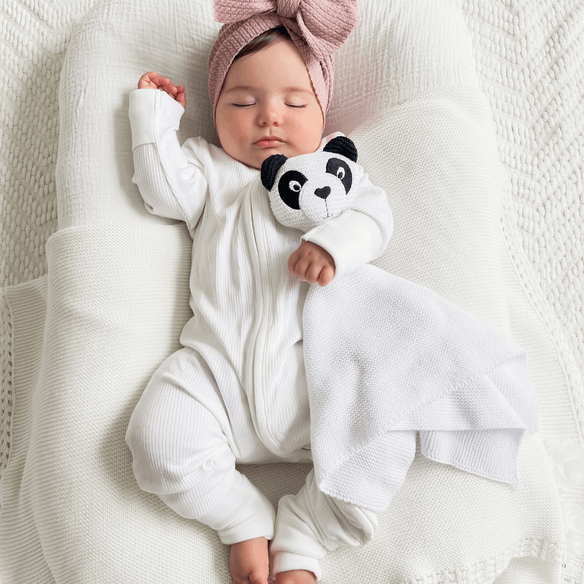 Baby asleep wearing the GrowGrows White Ribbed Sleepsuit