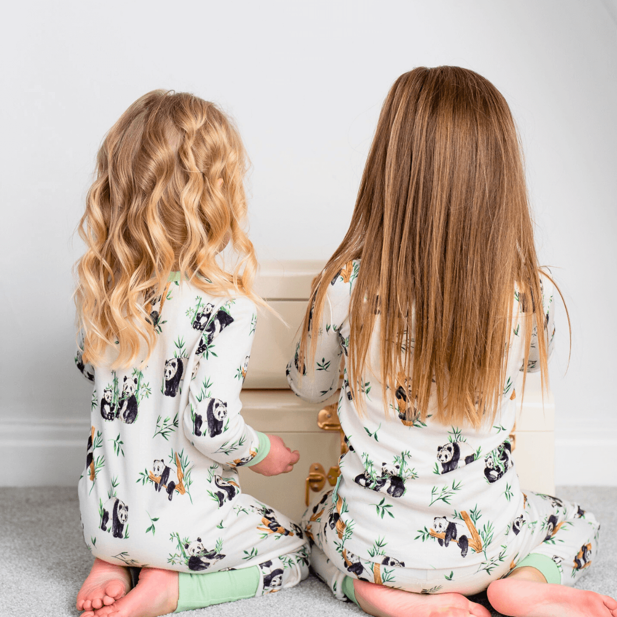 Girls sat next to each other wearing Bamboo Baby Clothes from GrowGrows
