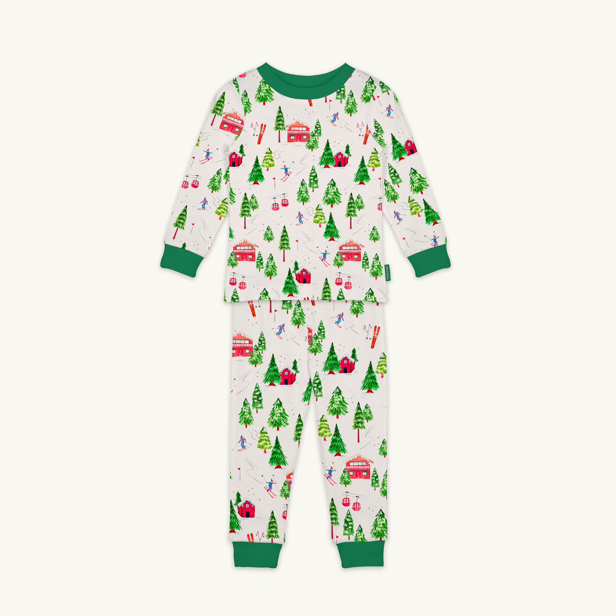 Alpine Adventures Pyjamas with chalet, fir tree and skier print and forest green trim made from bamboo and organic cotton from GrowGrows on white background