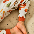 Close up on the legs and cuff of the Autumnal Amazes Pyjamas with pumpkin and autumn print made from bamboo and organic cotton from GrowGrows