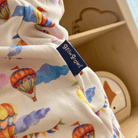 Up, Up & Away Sleepsuit with hot air balloon and cloud print made from bamboo and organic cotton from GrowGrows close up of the hand-drawn print and label